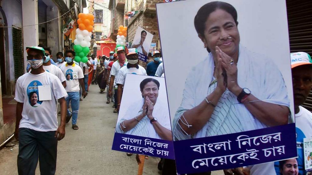 Trinamool Congress supporters hold placards during an election rally in Kolkata | ANI