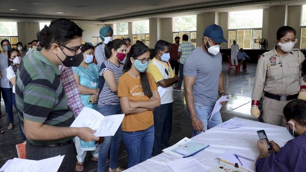 Representational image| People stand in queues to register themselves for COVID-19 vaccine dose, in Amritsar | PTI