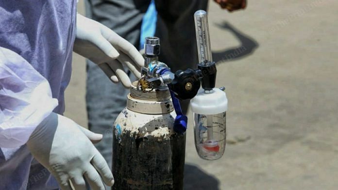 A healthcare worker handling an oxygen cylinder | Representational image | Photo: ThePrint