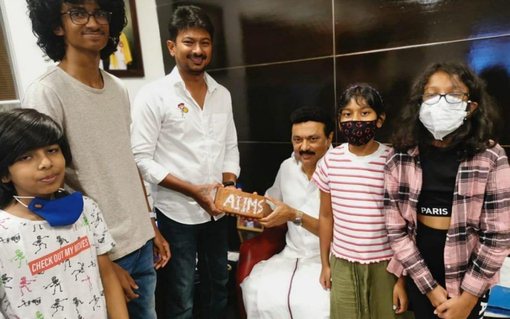 Udhayanidhi Stalin with his father, DMK chief M.K. Stalin, and that AIIMS brick | Twitter/@Udhaystalin