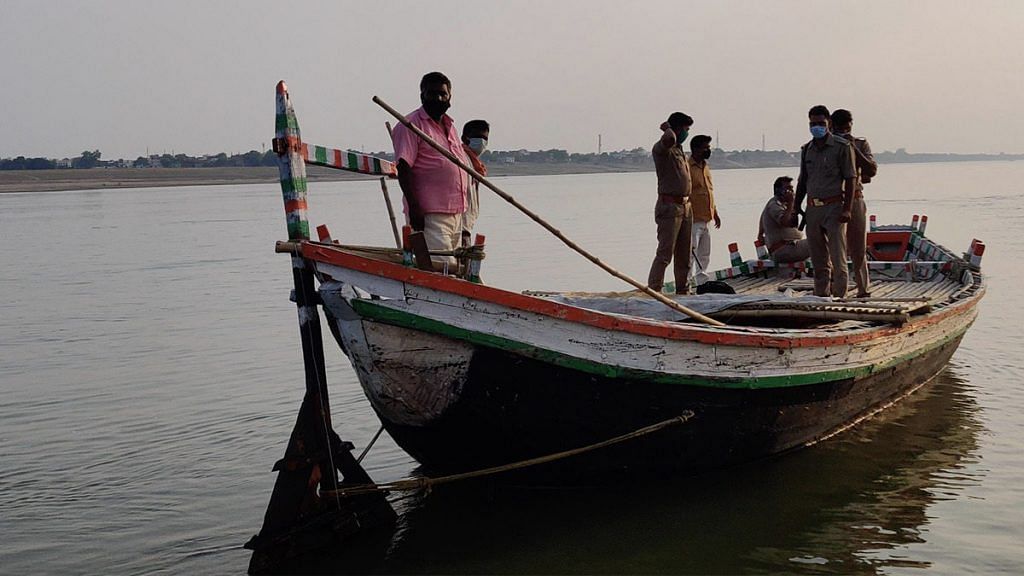Policemen patrol the Ganga in a civilian boat | Photo: Sajid Ali | ThePrint
