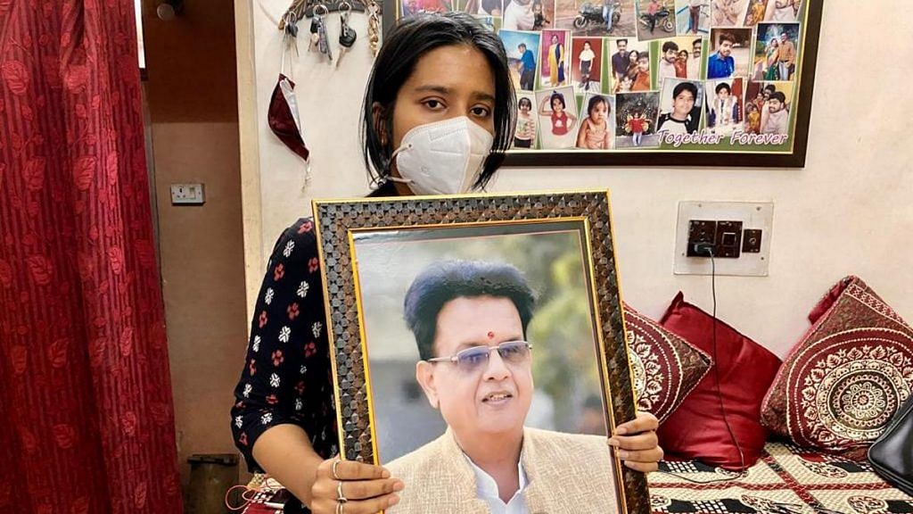 Sonakshi holding a photograph of her late father, BJP leader Devnarayan Shrivastava, in Damoh, MP. Devnarayan contracted Covid during a bypoll campaign in April and died | Photo: Nirmal Poddar | ThePrint