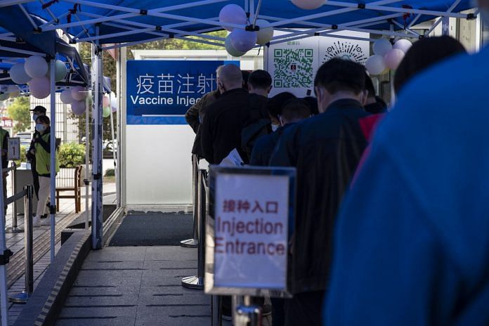 People stand in line outside a Covid-19 vaccination centre at Shanghai, China | Representational image | Qilai Shen/Bloomberg