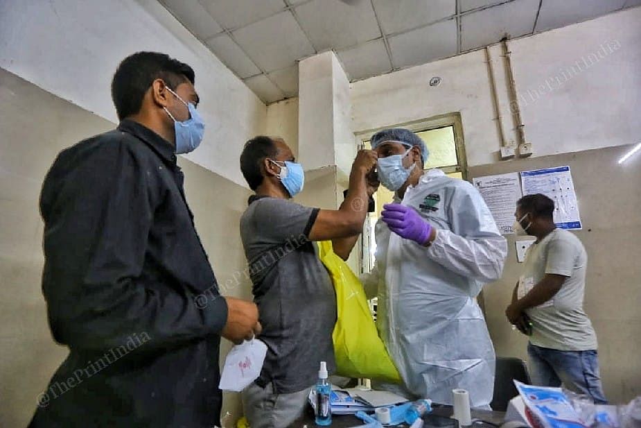 Covid superintendent Dr Prashant Gupta getting ready to go to the patient ward at the Sarojini Naidu Medical College and Hospital in Agra. | Photo: Praveen Jain/ThePrint 