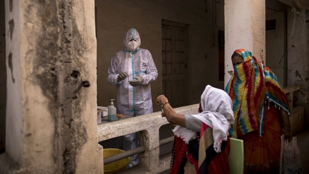 A health worker prepares for a swab sample to be taken at a Covid-19 testing site in Agra, Uttar Pradesh, on 3 May 2021 | Photographer: Anindito Mukherjee | Bloomberg