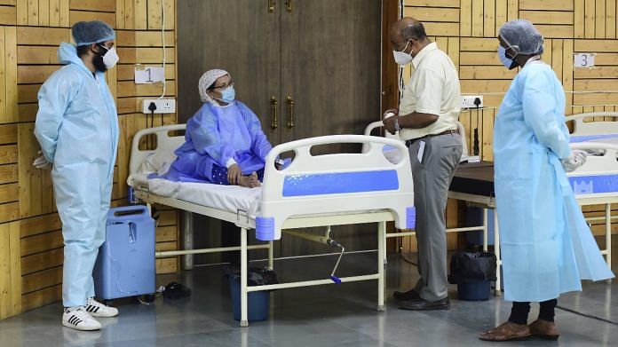 A doctor and health workers attend a Covid-19 patient at a care centre in Dwarka, New Delhi, on 10 May 2021 | PTI
