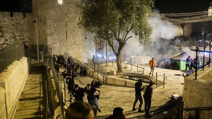 Palestinians clash with Israeli police officers at Damascus Gate in Jerusalem, on 8 May 2021 | Bloomberg