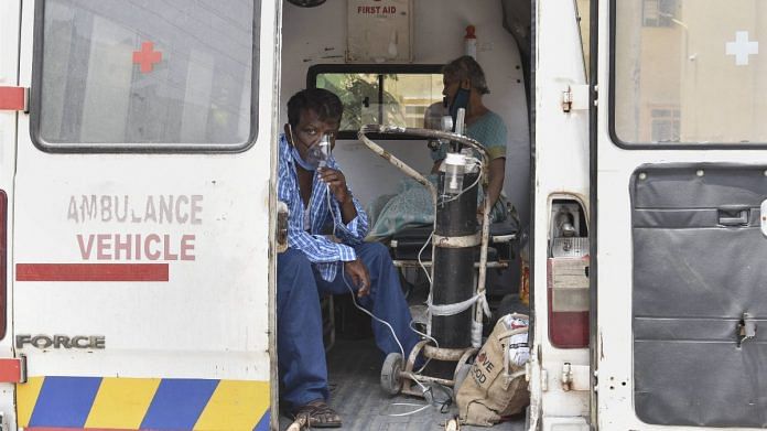 A Covid patient on oxygen support waits in an ambulance outside the District Hospital Koti in Hyderabad, on 7 May 2021 | PTI
