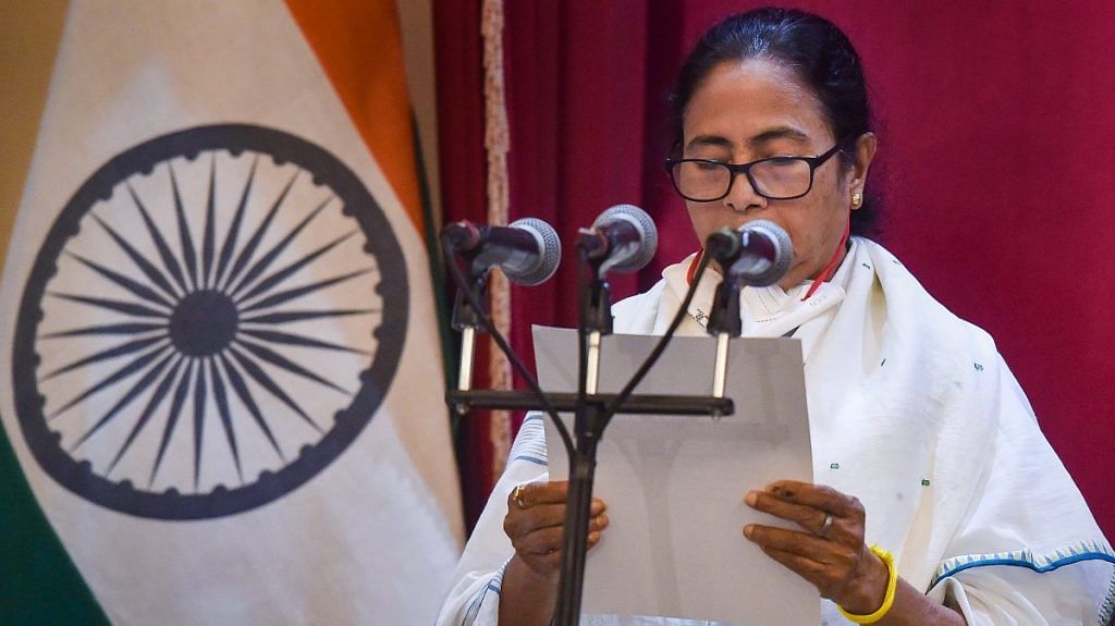 TMC supremo Mamata Banerjee takes oath as the CM of West Bengal for the third time consecutively during her swearing-in-Ceremony at Governor House in Kolkata, on 5 May 2021 | PTI