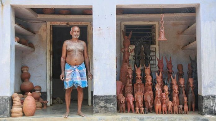 A terracotta craftsmen stands outside his workshop where different sizes of the 'Bishnupur horse' can be seen on display, in Panchmura village, West Bengal | Manisha Mondal | ThePrint