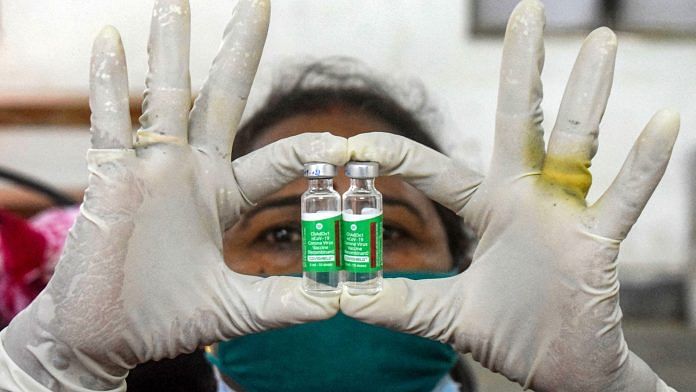 A health worker with Covid-19 vaccine vials, at a vaccination centre, in Prayagraj, on 17 June 2021 | PTI
