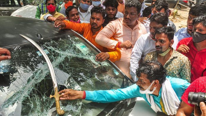 BJP workers show a sword on a damaged vehicle after clash with farmers protesting at Ghazipur border in New Delhi on 30 June 2021 |Photo: PTI