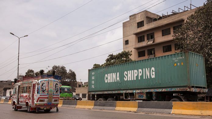 A truck transports a China Shipping Container Lines container along Karachi port road in Karachi