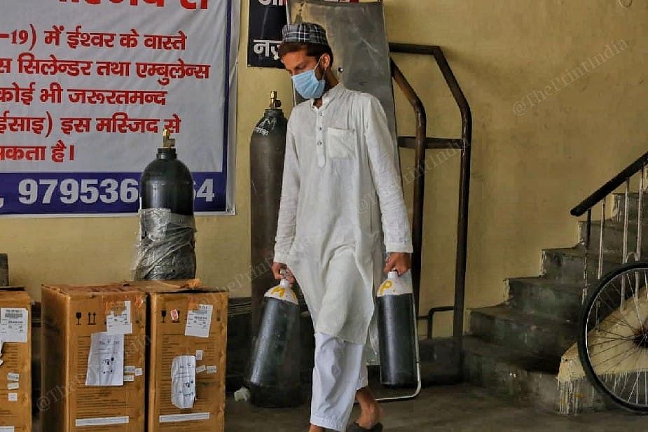 A volunteer carries oxygen cylinders at Jama Masjid Kapurthala | Praveen Jain | ThePrint