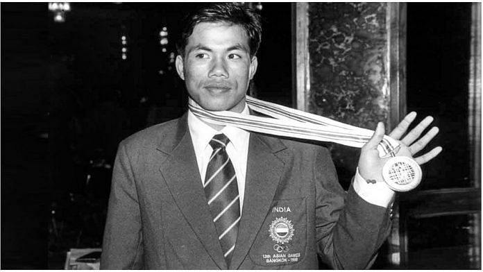 In this file photo circa 1998, boxer Dingko Singh shows his gold medal after winning at the Asian Games | PTI