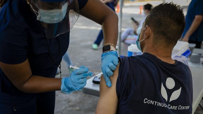 A healthcare worker administers a dose of Johnson & Johnson Covid-19 vaccine in Miami, Florida | Photographer: Eva Marie Uzctegui/Bloomberg