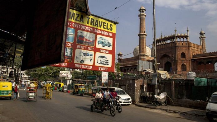 Traffic travels past the Jama Masjid mosque as lockdown restrictions are eased in New Delhi, on 16 June 2021 | Bloomberg