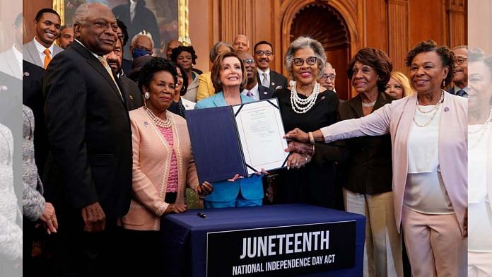 Speaker of the House Nancy Pelosi holds a bill enrollment signing ceremony for the Juneteenth National Independence Day Act on Capitol Hill on June 17 | Bloomberg