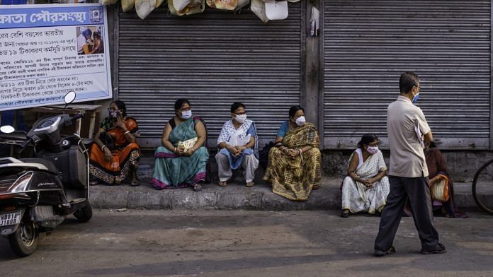 People wait outside a Covid-19 vaccination centre in Kolkata | Photo: Arko Datto | Bloomberg File Photo