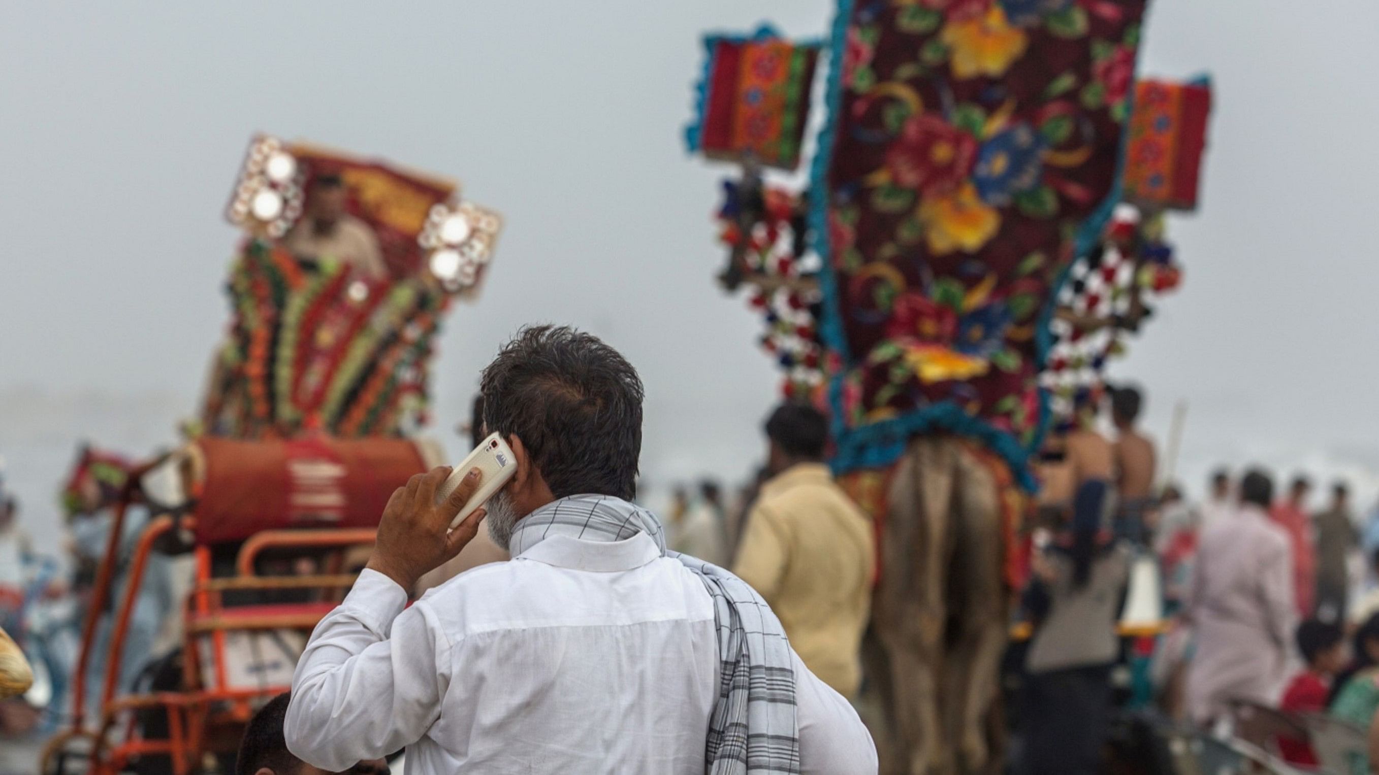 A man uses a mobile phone at Clifton Beach in Karachi