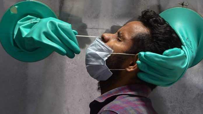 Representative Image | File photo of a swab sample being collected for Covid test | PTI