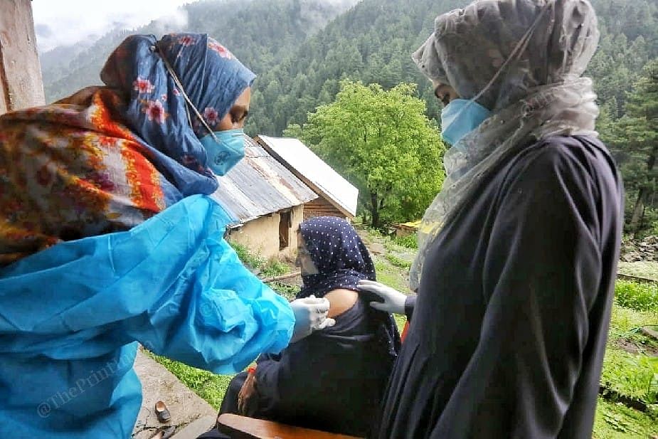Health workers Abida Quayoom and Smashad Akhtar vaccinating local residents at the Naranag village in Kashmir | Photo: Praveen Jain | ThePrint