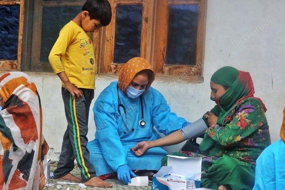 Health worker checking blood pressure before the vaccination at the Mantrigam village in Bandipora Distt in Kashmir | Photo: Praveen Jain | ThePrint