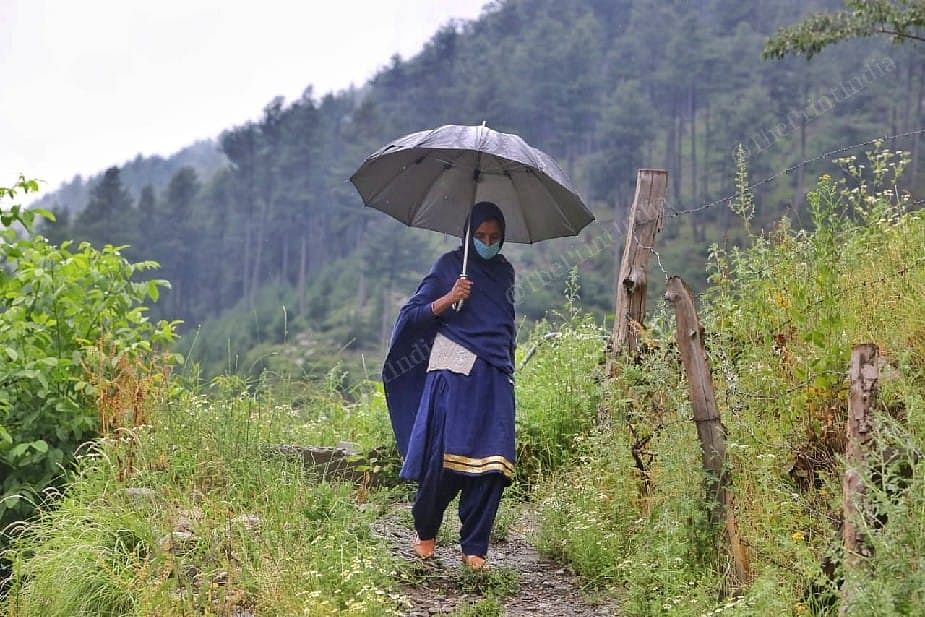 Asha worker Ruheela Adil Rasheed walking on the road to go her health center at Naranag village | Photo: Praveen Jain | ThePrint