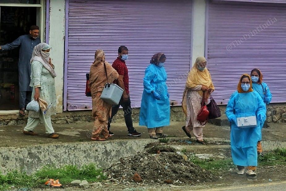 Health worker along with Dr Shajia and Asha workers during vaccination campaign going shop to shop at the Mantrigam village in Bandipora Distt in Kashmir | Photo: Praveen Jain | ThePrint