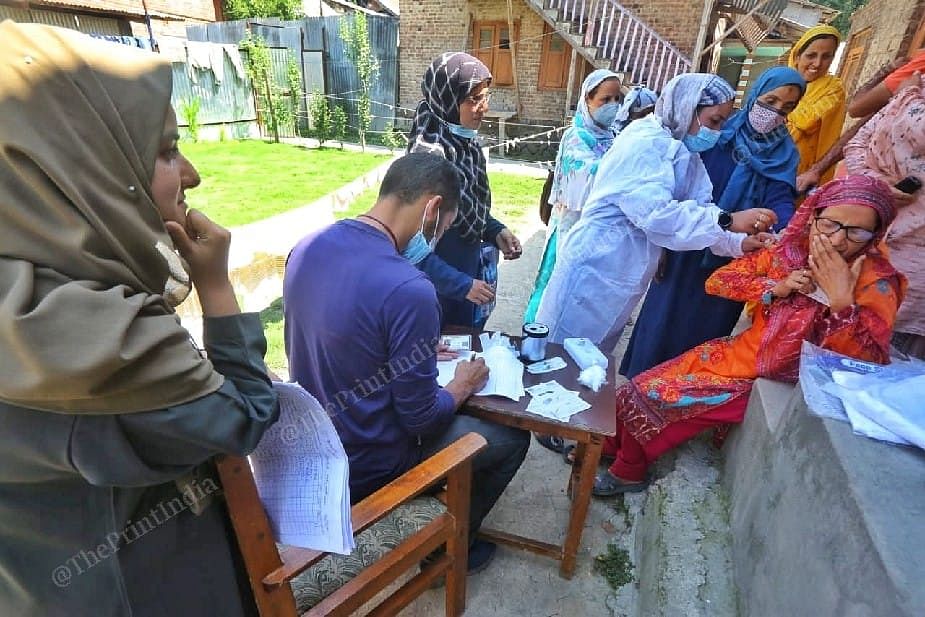 Medical staff with Asha workers going door to door for vaccination at the Akhoon Mohalla Abidal area in Srinagar | Photo: Praveen Jain | ThePrint