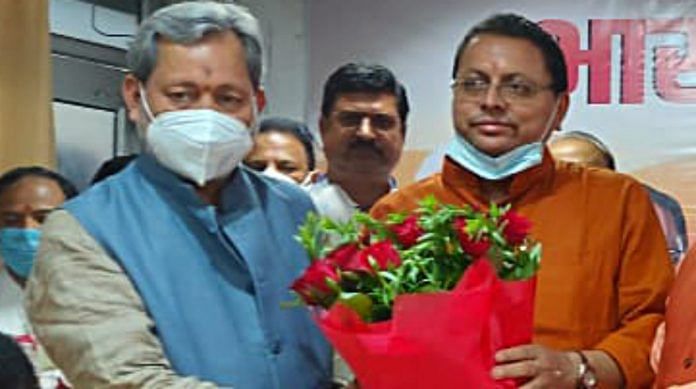 Outgoing Uttarakhand Chief Minister Tirath Singh with newly elected chief minister Pushkar Singh Dhami in Dehradun on Saturday | ANI