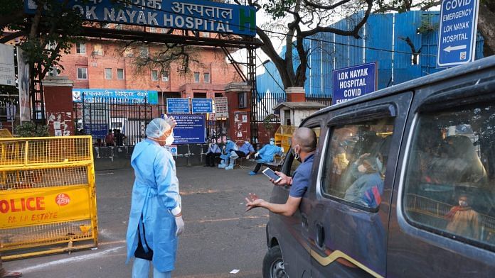 File photo of a health worker assisting an ambulance outside a hospital | Photographer: T. Narayan | Bloomberg
