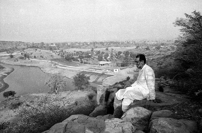 Prime Minister Chandra Shekhar enjoying the view of a lake from the top of rock at his ashram | Photo: Praveen Jain