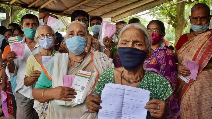 Beneficiaries show their Aadhar cards, other documents while they wait to register for Covid-19 vaccine dose, at a vaccination centre in Nadia, West Bengal on 16 July 2021 | PTI