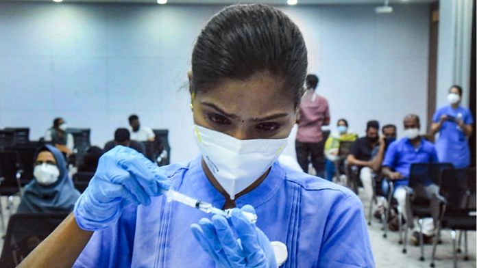 A health worker prepares a dose of the Covid-19 vaccine to administer to a beneficiary in Kochi on 13 July 2021 | Photo: PTI