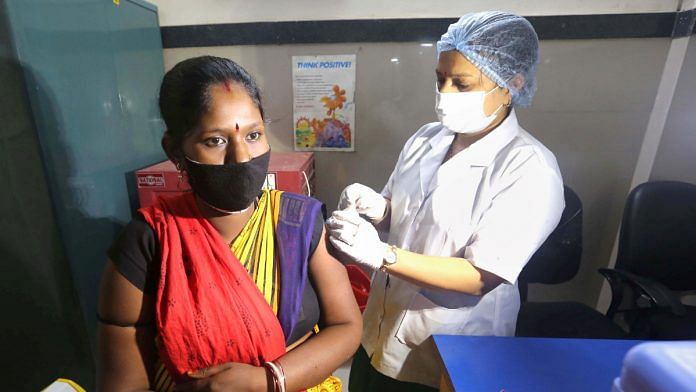 A medic administers a dose of Covid-19 vaccine to a beneficiary at a government hospital in Bhopal on 23 July 2021 | PTI