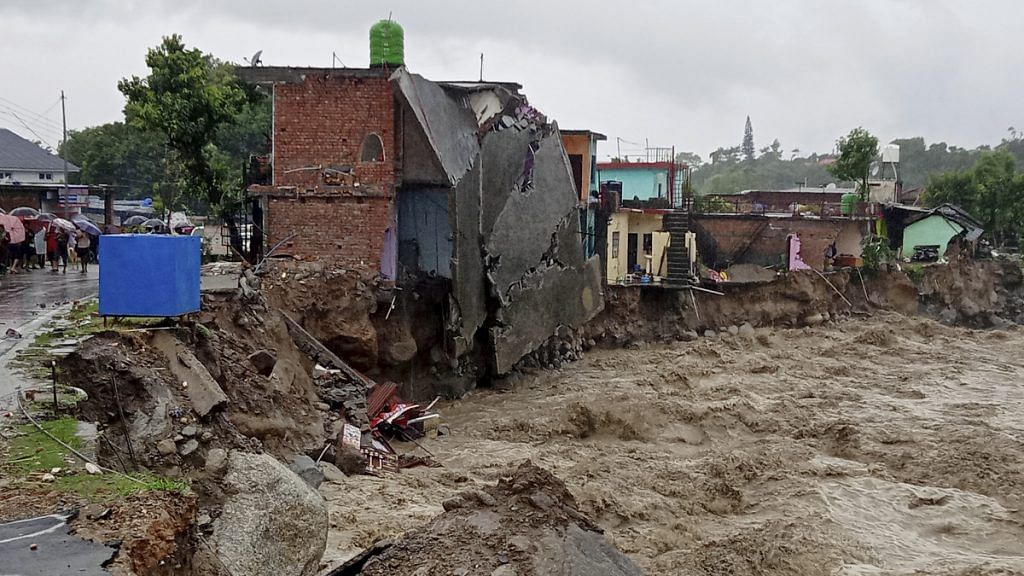 A partially washed away house amid flood water as heavy rain lash after a cloudburst in Dharamshala on 12 July 2021| Photo: PTI