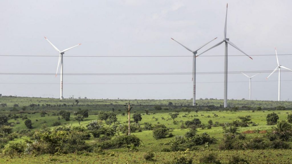 Wind turbines operating beyond electricity cables in Lahori, India |Photographer: Dhiraj Singh/Bloomberg