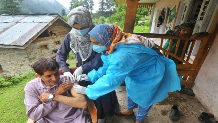 Health workers Abida Quayoom and Shamshada Akhtar vaccinating local residents at the Naranag village, Ganderbal district, in Kashmir | Praveen Jain | The Print