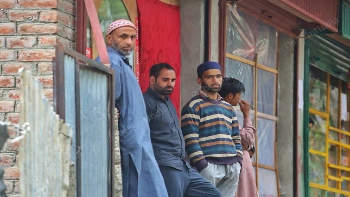 Shopkeeper Mohammad Ashraf ( in a black shirt ) said he does not ‘trust the vaccine of India’. He is waiting for the Pfizer vaccine. | Praveen Jain | The Print