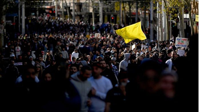 Hundreds of anti-lockdown protesters take to the streets during a rally in Sydney on 24 July 2021 as thousands of people gathered to demonstrate against the city's month-long stay-at-home orders. Photo: Steven Saphore/AFP/Getty Images via Bloomberg