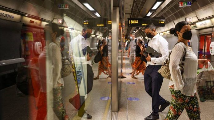 Commuters board a train at Waterloo London Underground station in London, on 19 July 2021 | Hollie Adams | Bloomberg