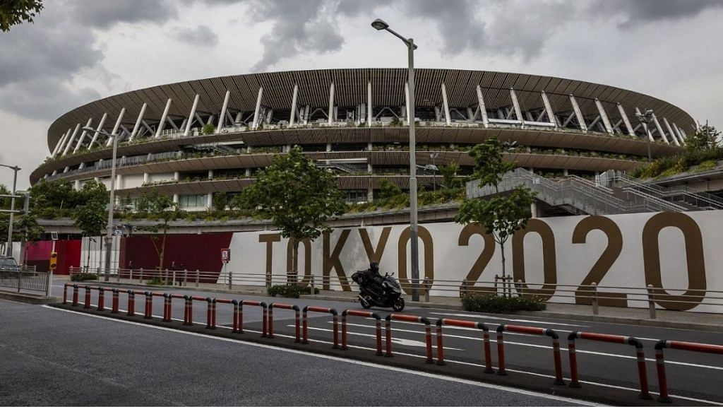 A man drives past the New National Stadium, the main stadium for the Tokyo Olympics, on 3 June 2021 in Tokyo | Photographer: Yuichi Yamazaki/Getty Images via Bloomberg
