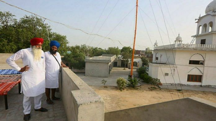 Ranjit Singh (L), who was the president of the gurdwara at Burj Jawahar Singh Wala village when it was targeted with sacrilege in 2015, and Gora Singh, the granthi or priest, at the shrine | Praveen Jain | ThePrint