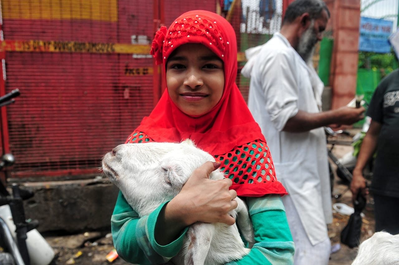 A kid holds a goat at the market | Suraj Singh Bisht | ThePrint