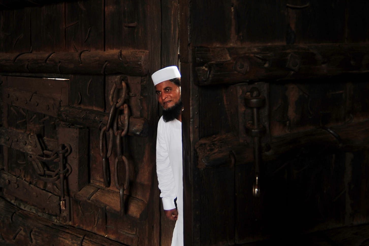 The caretaker of the Jama Masjid mosque of Delhi looks inside the Gate after it was closed to public | Suraj Singh Bisht | ThePrint