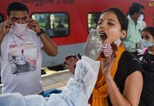 A BMC health worker collects a swab sample of a passenger for the Covid test, at a station in Mumbai, on 30 June 2021 | PTI