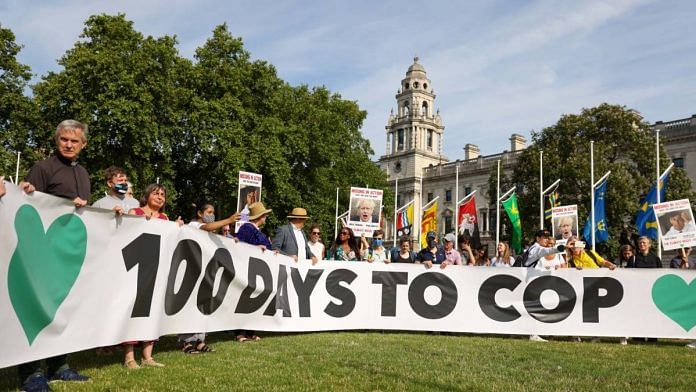 Protesters hold a banner reading '100 Days To Cop' during a demonstration marking 100 days until COP26 in London, on 23 July 2021 | Photographer: Hollie Adams | Bloomberg