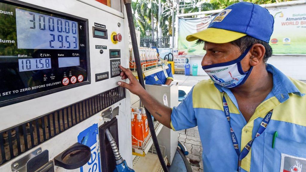 A pump attendant fills petrol in a car at a refilling station in New Delhi, on 15 July 2021 | PTI