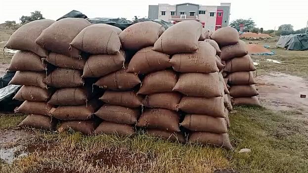 Sacks of paddy crops soaked in the rain at a procurement center, in Tamil Nadu